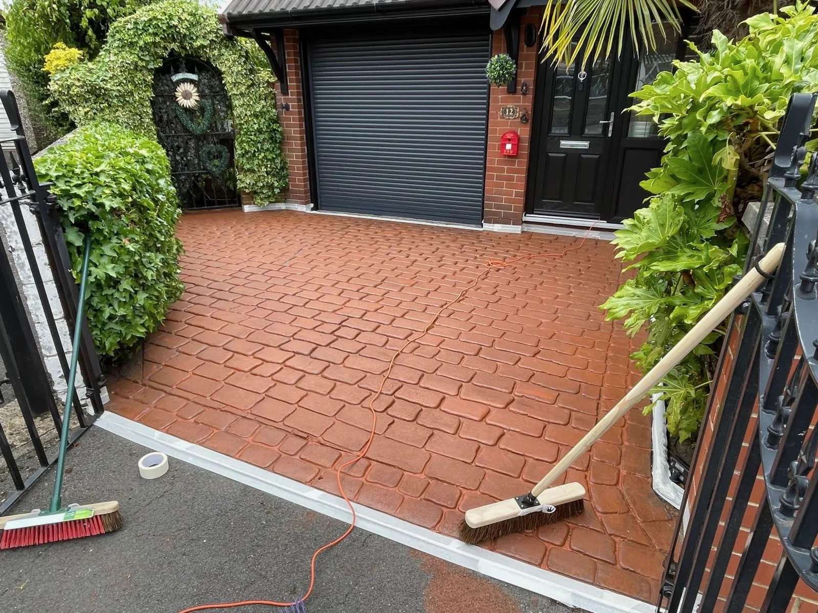 Orange concrete imprint driveway before cleaning and colour work.